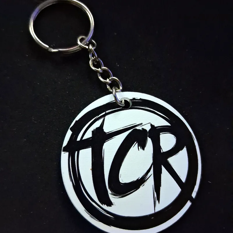 Round TCR seal charm keychain on a split ring and chain