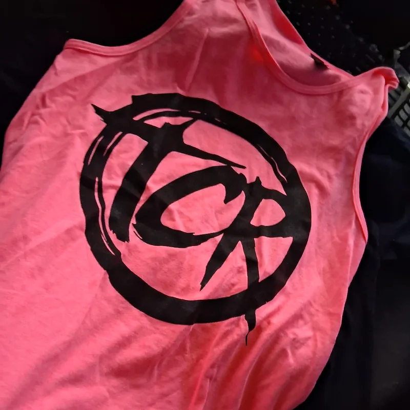 Pink tank top with a large black TCR seal print